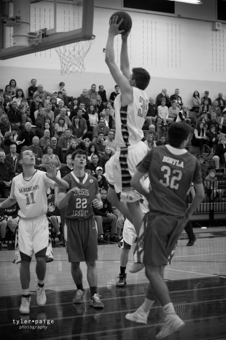 SaberCat player finishing at the rim in an archival black-and-white game photo