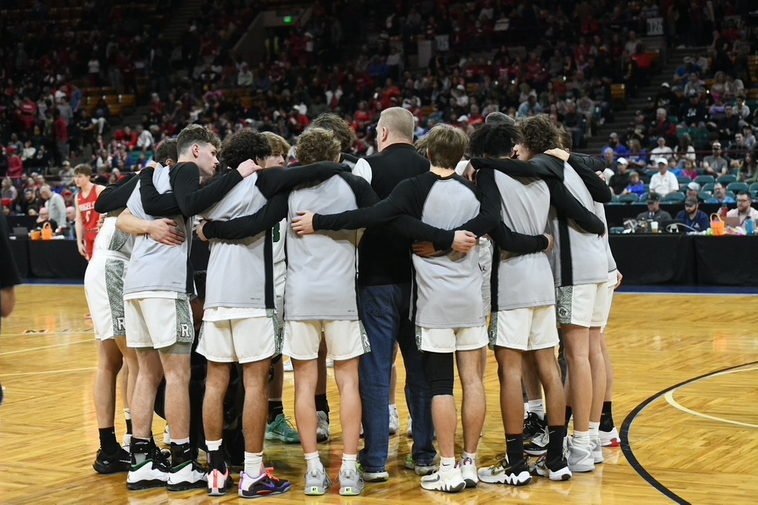 Fossil Ridge SaberCats basketball team gathered in a huddle at the state tournament